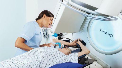 Health care worker with a patient using active breathing coordinator on a Versa HD